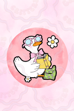 Load image into Gallery viewer, Sticker with a silly white goose holding a yellow book, wearing pink flower sunglasses, a pink bow, and green daisy-pattern rain boots. The goose is shown on a soft pink circle with a white daisy beside it, giving the design a playful Cafe Critterz spring reading vibe.

