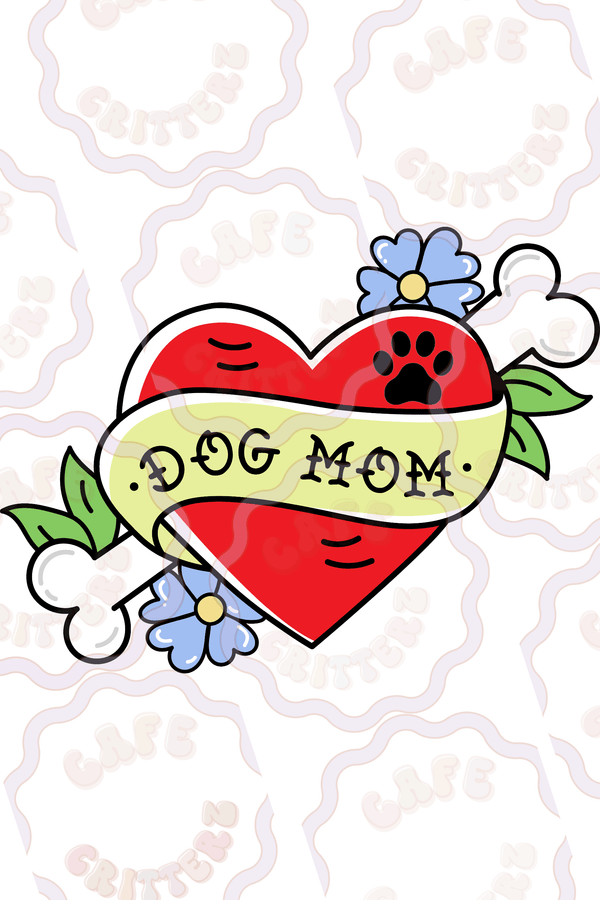 Retro tattoo-inspired "dog mom" sticker featuring a bright red heart wrapped in a pale yellow banner with “Dog Mom” lettering. The playful design includes a black paw print, blue flowers, green leaves, and white bone accents for a sweet vintage feel with a cozy Café Critterz twist.