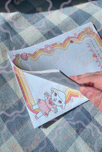 Load image into Gallery viewer, Cafe Critterz style 5" x 7" Sleepy Sweet memo pad featuring a cute cartoon lamb character illustrated in a whimsical lolita inspired design. This retro floral notepad includes decorative rainbow borders and spring picnic blanket details for a playful, cozy aesthetic. Perfect for writing to do lists, reminders, journaling notes, and daily planning, this memo notepad also makes a charming addition to junk journals, scrapbooks, planners, and other creative craft projects

